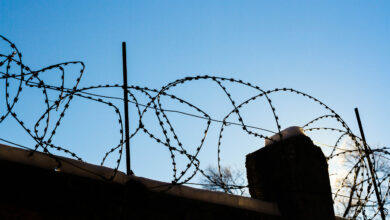 Bigstock Barbed Wire On The Prison Fenc 473131677 Scaled 390x220