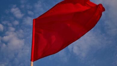 Bigstock Red Flag With Blue Sky With Cl 420328258 Scaled 390x220