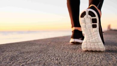 Runner man feet running on road closeup on shoe. Male fitness at