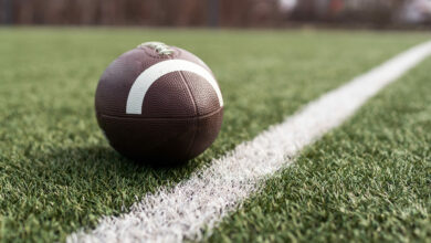 Bigstock American Football Ball On Gree 474752801 Scaled 390x220