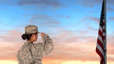 Closeup of an American Female Soldier in combat uniform saluting